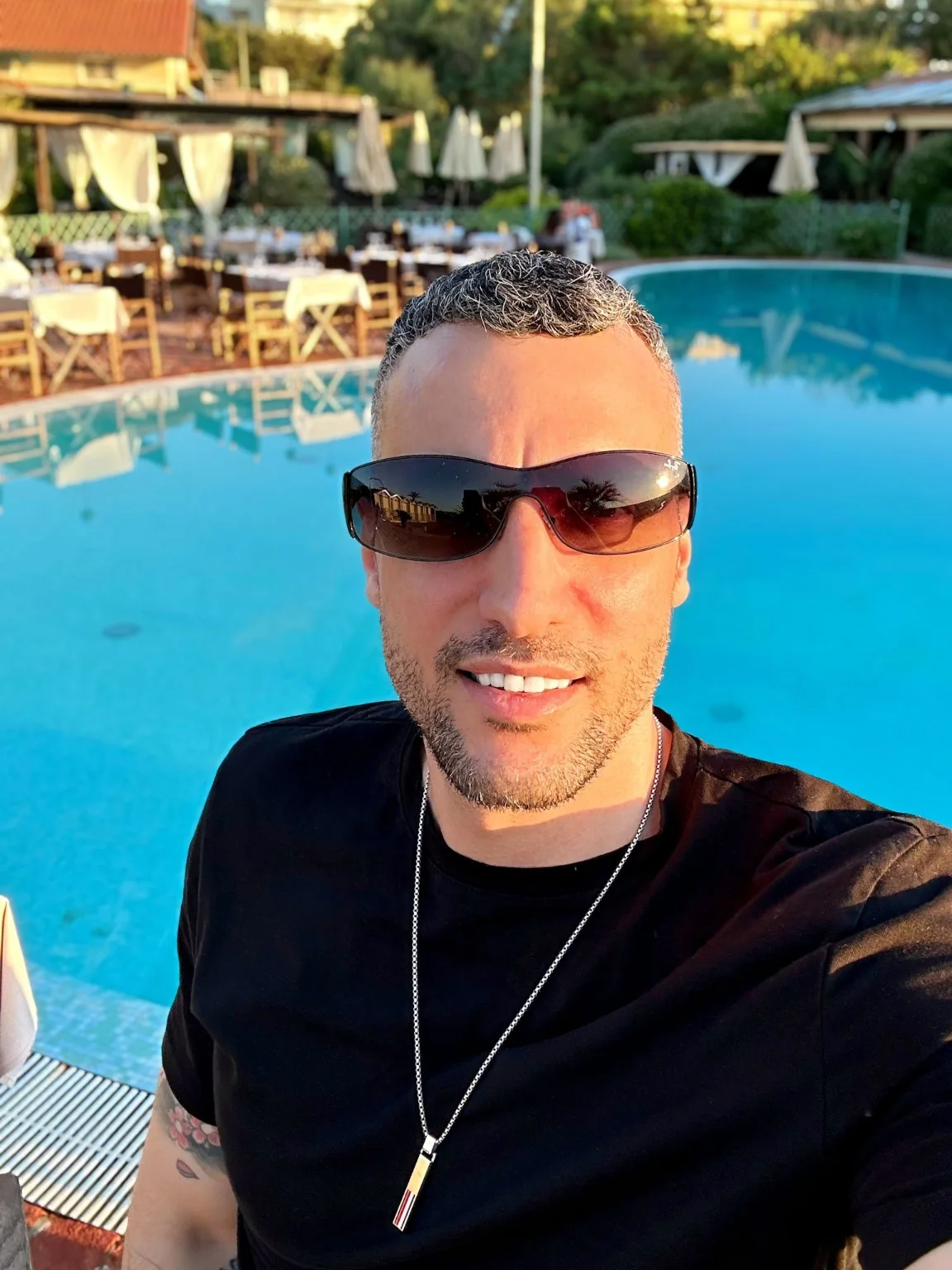 Michael by a pool in a relaxed setting